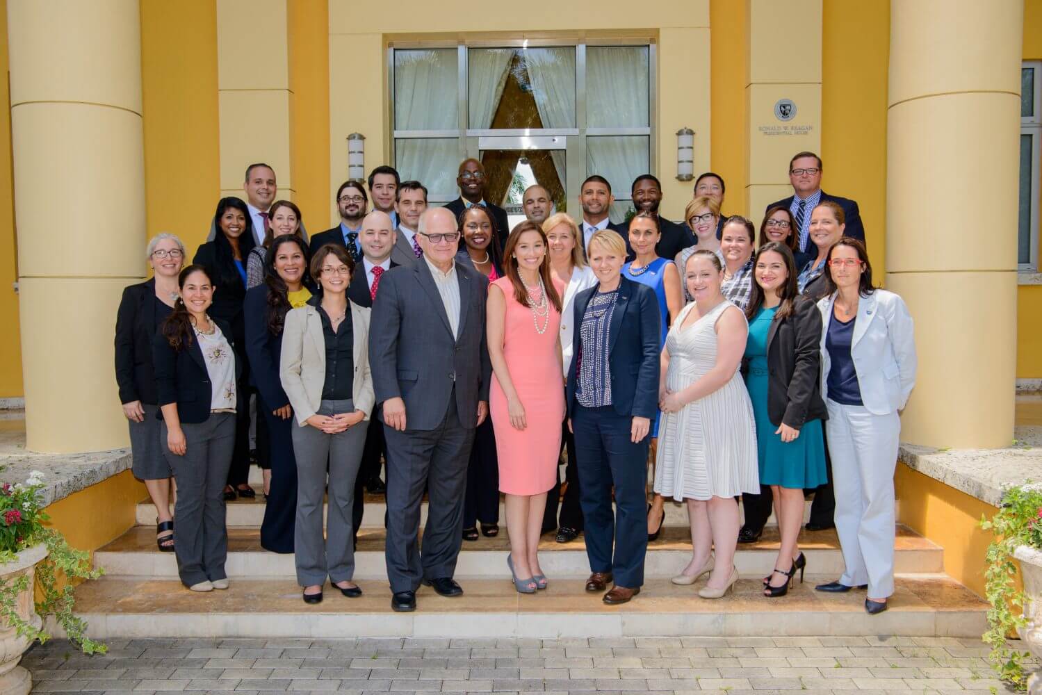 A group photo of cohort #1 of the President's leadership program standing in front of the Ronald W. Reagan Presidential House