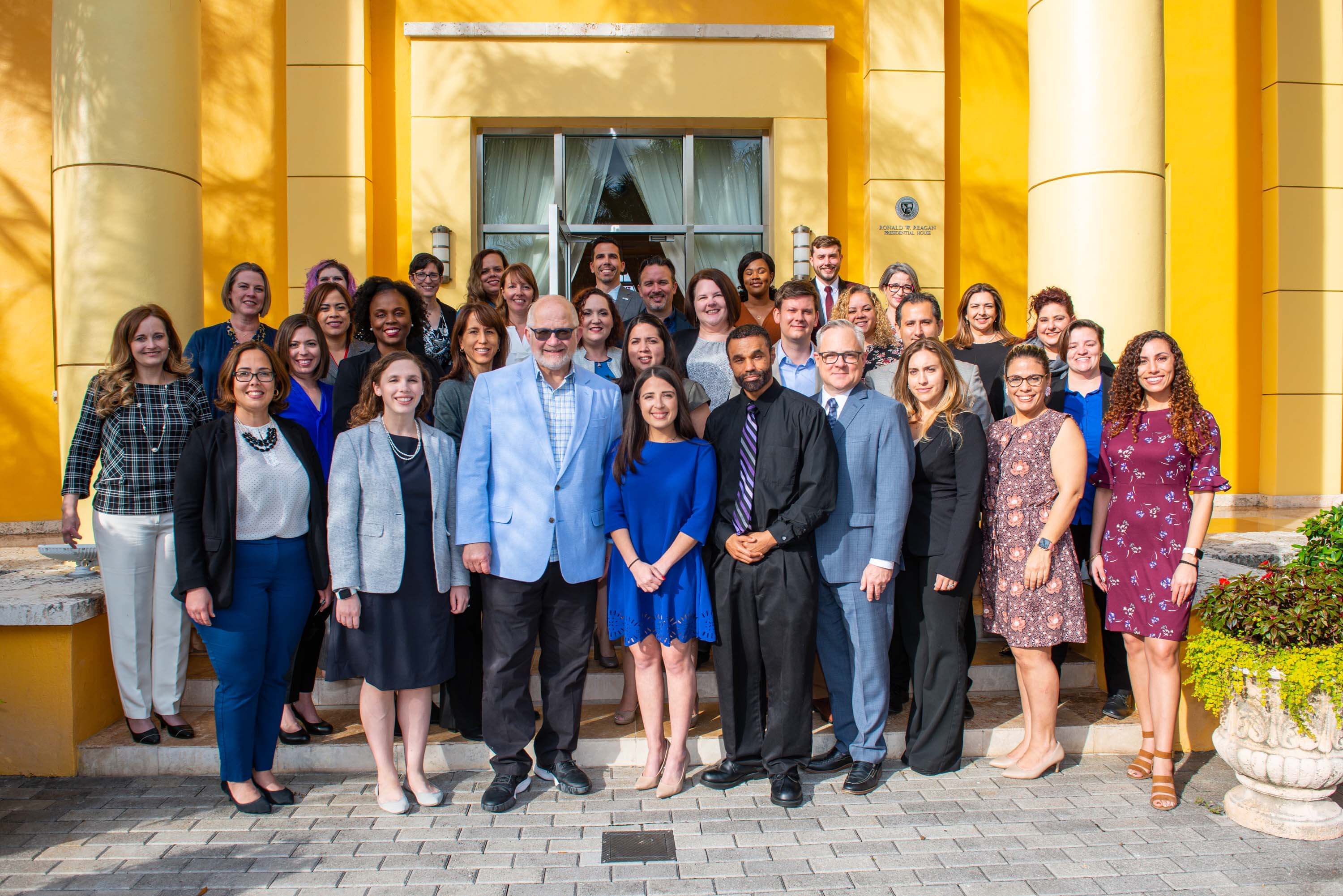 A group photo of cohort #4 of the President's leadership program standing in front of the Ronald W. Reagan Presidential House